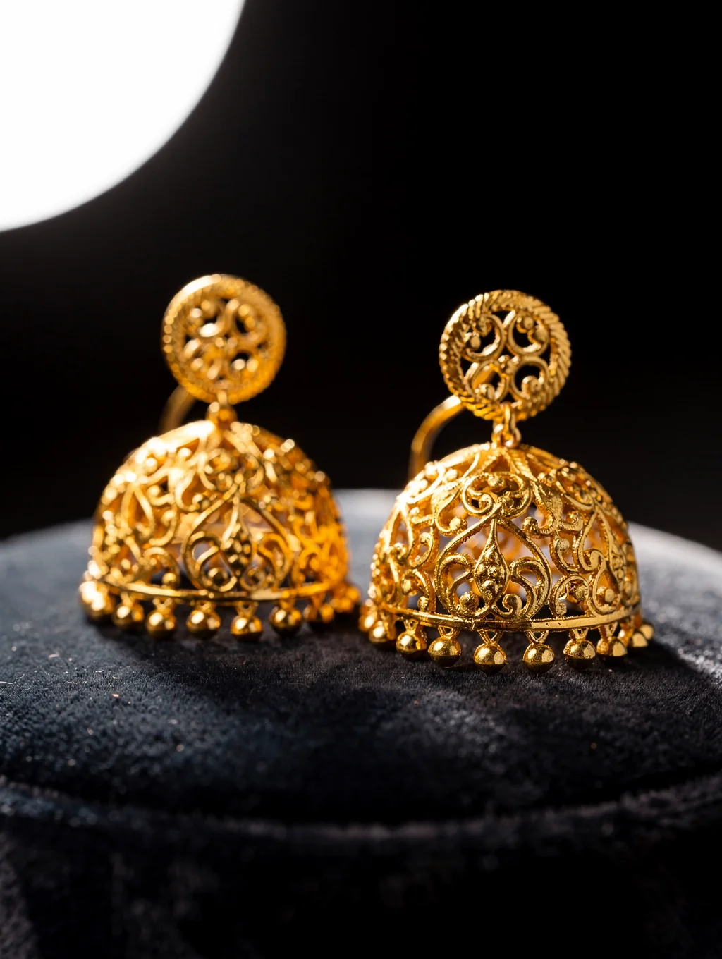 Macro detail of intricate gold filigree work under warm studio lighting